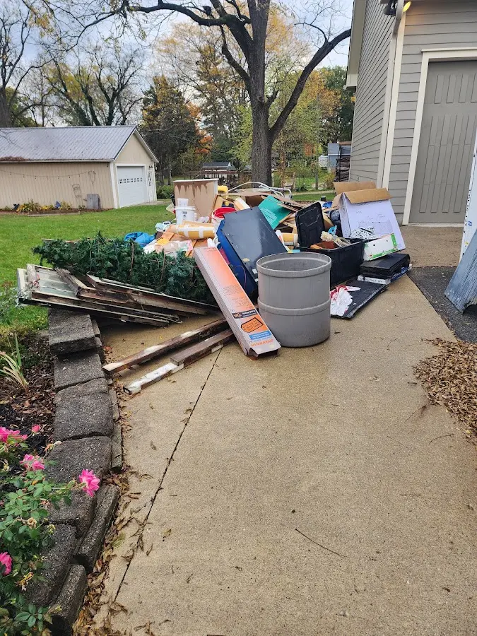 Dumpster being loaded with debris for Estate Cleanout Dumpster Rental in Shorewood
